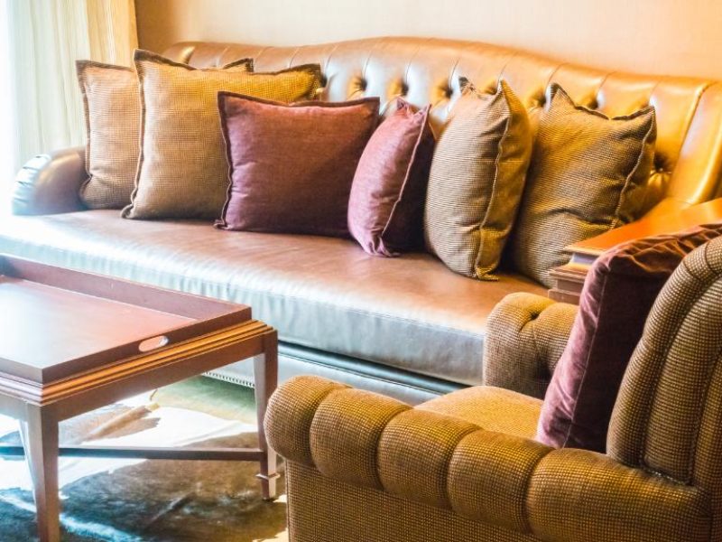 wooden-table-close-couches-with-cushions